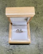 A 9ct gold three stone twist diamond ring, size L/M.