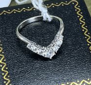 An 18ct white gold and diamond wishbone ring, size M/N.