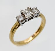 An 18ct yellow gold three stone diamond ring, comprising one central princess cut diamond approx 0.