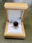A 9ct yellow gold ring set with a dark stone, size H/I