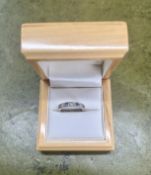 A white metal diamond and sapphire half band ring, size K/L, hallmarked rubbed.