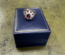 A 9ct gold garnet and diamond cluster ring, size O