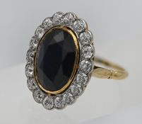 A beautiful large sapphire and diamond cluster ring, size L/M.
