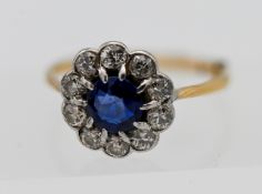An 18ct yellow gold diamond and sapphire cluster ring, with fitted sizer, size M, in Garrard & Co
