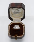 An impressive Art Deco solitaire ring, approx 2.50ct set with smaller diamonds to the shoulders,