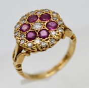 An Edwardian style 18ct yellow gold diamond and ruby cluster ring, size K/L.