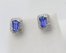 A pair 14k earrings, white gold rectangular tanzanite and diamond.