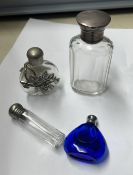 Four scent bottles including silver mounted together with a Chinese carved soapstone figure,