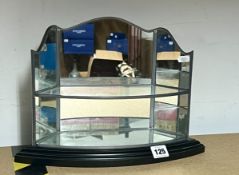 A two tiered mirrored glass stand, unboxed.