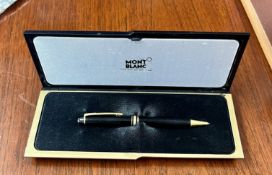 A Mont Blanc Meisterstuck gold-coated ballpoint or rollerball pen with case, black with golden