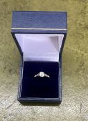 An 18ct yellow gold diamond solitaire with further diamonds to the shoulders, approx centre stone