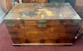 An early 19th century camphorwood campaign chest with brass military mounts, recessed military