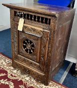 A carved wood Spanish style side cabinet with key. 61cm wide.