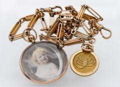 A 9ct gold watch chain with elongate links, T bar, 9ct lobster pendant, attached a 9ct glass