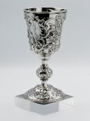 A Victorian London silver cup, richly embossed with stylised flowers and cartouche, approx, 9.