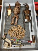 A collection of West African carvings including fertility figures, carved wood bead necklace, tribal