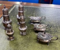 A collection of four pepper pots and three mustard pots with spoons, total weight 9.90oz
