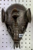 An African Dan mask, in metal stylised elephant design.