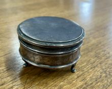 A hallmarked silver circular ring box on 3 feet [RE 713657], make of 'Walker & Hall Sheffield', with