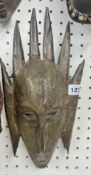 An African metal Dan mask.