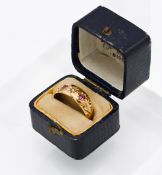 An 18ct yellow gold ruby and diamond Gypsy style ring, size M.