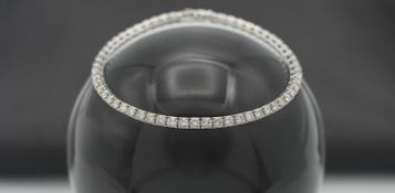 An 18ct white gold diamond line bracelet, set with fifty seven diamonds, total diamond weight 4.