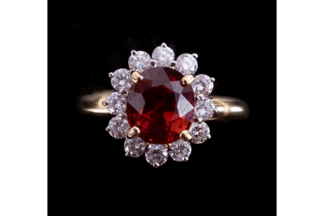 An 18ct yellow gold cluster ring set with a central oval cut orange garnet, approx. 2.50 carats, - Image 2 of 2