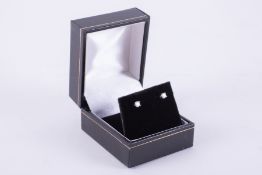A pair of platinum studs set with a round brilliant cut diamond, total diamond weight 0.20 carats,