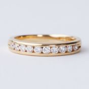 An 18ct yellow gold half eternity ring set with round brilliant cut diamonds, total diamond weight