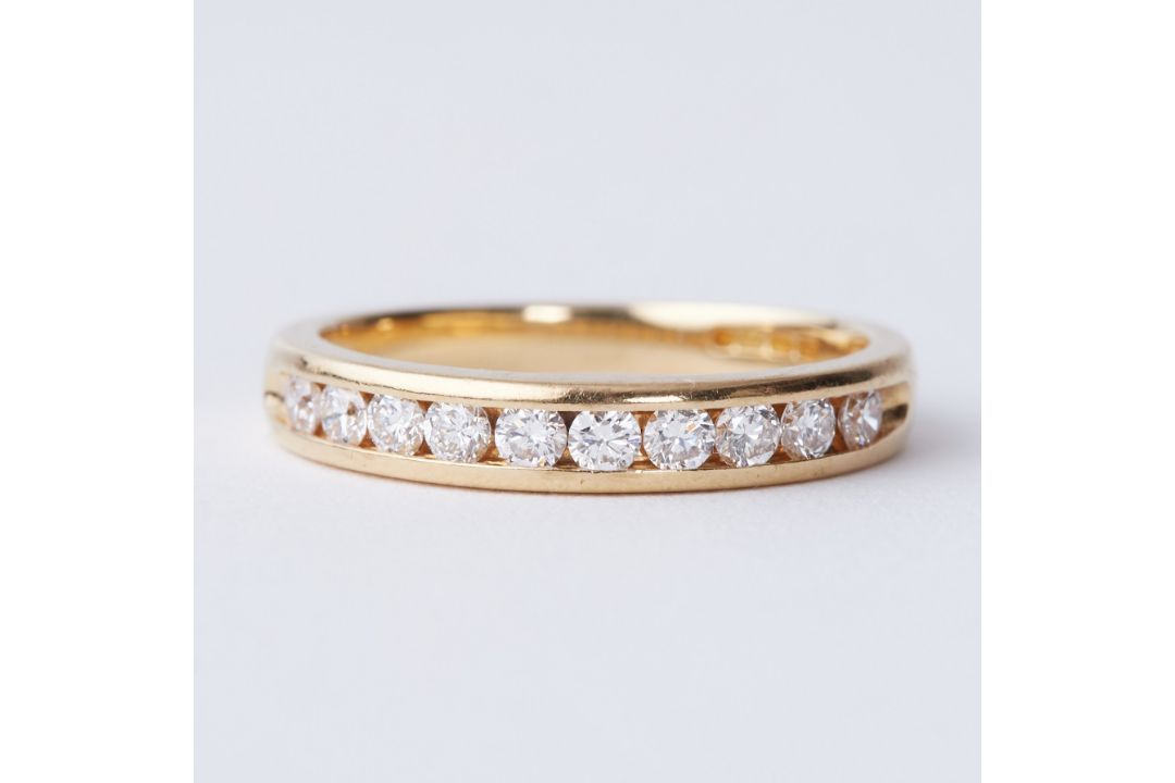 An 18ct yellow gold half eternity ring set with round brilliant cut diamonds, total diamond weight