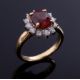 An 18ct yellow gold cluster ring set with a central oval cut orange garnet, approx. 2.50 carats, - Image 1 of 2