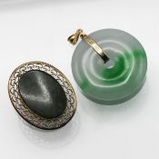 A 14k gold circular jade pendant together with a jade brooch.