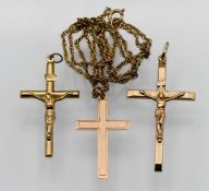 A 9ct gold cross on fine gold chain, together with two other cross pendants, approx 8g (3).
