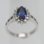 An 18ct diamond and sapphire ring, size M/N.