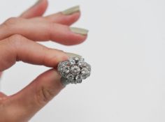A fine 18ct white gold diamond cluster ring, central diamond brilliant cut 0.75ct diamond,