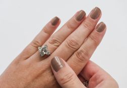 An 18ct white gold marquise cut diamond, approx 2.49ct set with two round diamonds and approx 0.30ct
