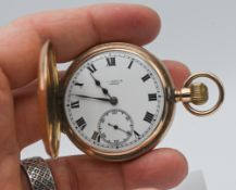 A 9ct gold half-hunter pocket watch, with keyless movement, a white enamelled dial with roman