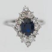 An 18ct white gold fine sapphire and diamond cluster ring, the central sapphire surrounded by