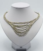 A stylish silver necklace with 'gold' bead decoration.