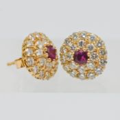 A fine pair of ruby and diamond earrings set in yellow gold.