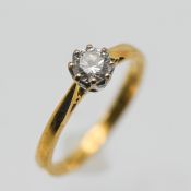 An 18ct yellow gold diamond solitaire ring, size M/N.