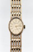 An 9ct yellow gold watch .H Samuel, gate bracelet style, quartz movement , champagne dial .17.5