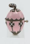 An enamelled egg shaped pendant with gothic style decoration, encrusted with seed pearl, hinged with