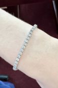 A diamond line bracelet set in white gold, length 20cm (fault).