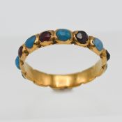 A Georgian turquoise and garnet set band ring (unmarked), size J/K.