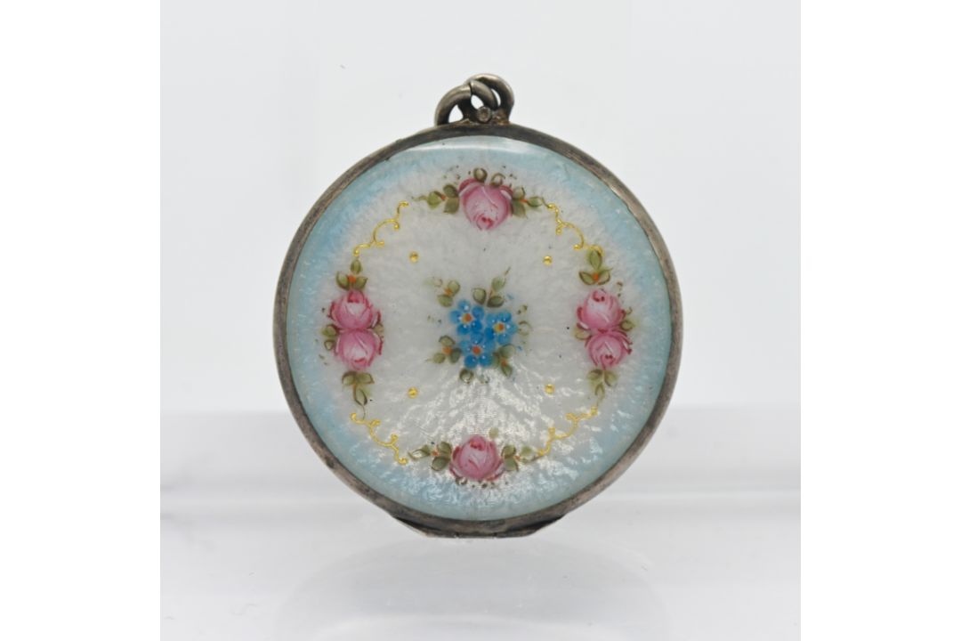 A silver and enamel? locket pendant.