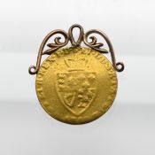 A George III gold Spade Guinea, mounted on a pendant, weight 4.5g.