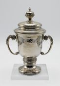 A silver trophy love cup with lid, with engraved foliate detailing, hallmarked Birmingham 1936,