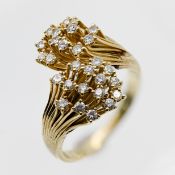 A 14k yellow gold diamond ring, with double flower formation, set with fifteen modern brilliant