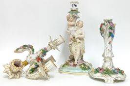 Two porcelain candlesticks, one in the form of a mother and child, height 31cm, together with a